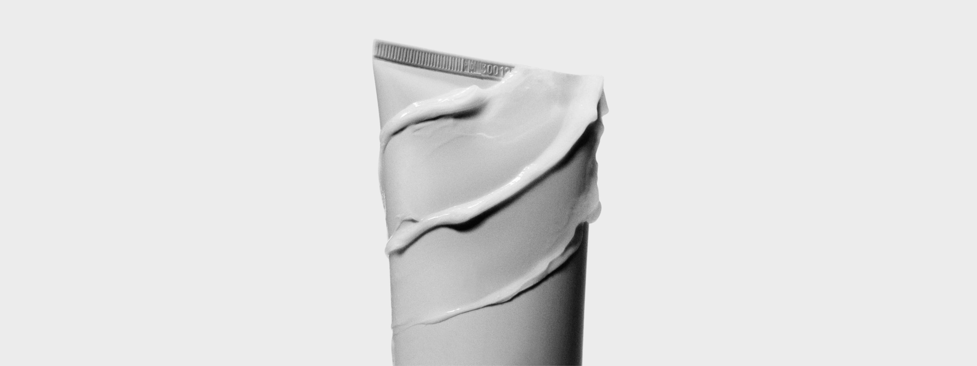 Toothpaste tube with smeared toothpaste.